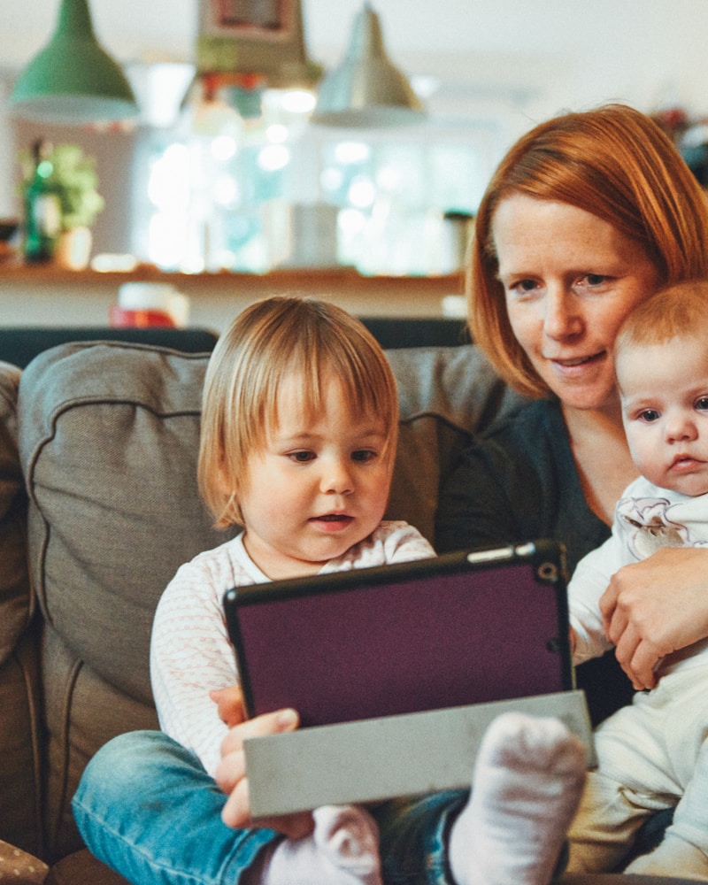 Family smiling together in a green park
